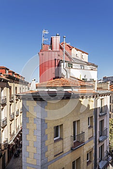 Facades of old buildings with roofs and attics and balconie photo