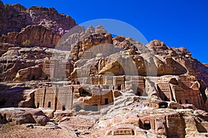 Facades of street of facades in Petra, carving in the mointains photo