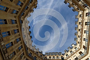 The facades of traditional French houses with typical balconies and windows. Paris.