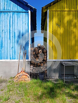 Facades of two country houses in different bright colors, manor courtyard