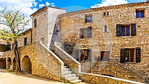 Facades of typical stone houses in the medieval village of Saint-Martin-de-londres in Occitanie, France photo