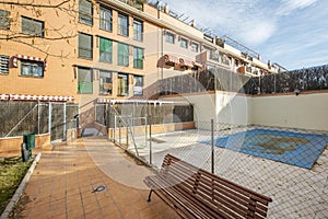 Facades of urban residential buildings with landscaped common areas and a pool covered with canvas to spend the winter with a clay photo