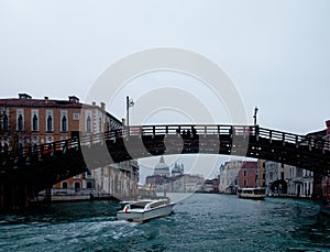 Facades of weathered buildings with windows on street of Venice city near canal water in daylight