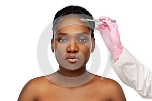 Face of african american woman and scalpel knife