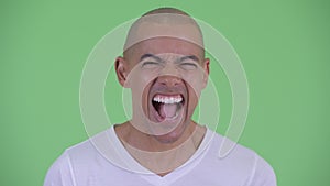 Face of angry bald man shouting and screaming