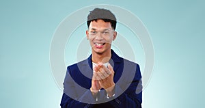 Face, applause and happy man pointing at you for congratulations in studio isolated on a blue background mockup space