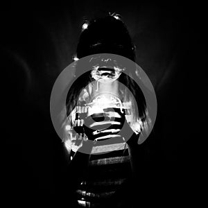 Face art girl with a glass jar in a hands with lights at night, black and white