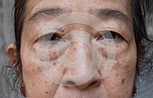 Face of Asian elder woman. Concept of aging photo