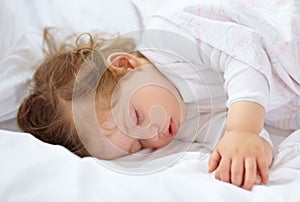 Face, baby and kid sleeping on bed for calm break, peace and dreaming to relax at home. Tired young child asleep with