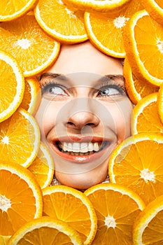 Face of a beautiful girl in orange slices