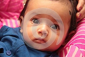 Face of Beautiful Infant smiling and looking with open eyes