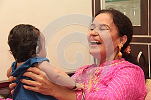 Face of Beautiful Infant smiling and playing with grand mother