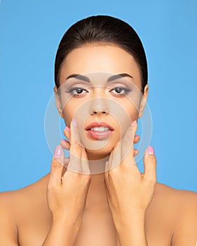 Face of a beautiful oriental brunette girl. Close-up portrait of young and attractive woman with brown eyes.