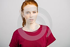 Beautiful young redhead girl with clean fresh face and neutral emotions close up