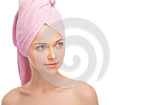 Face of a beautiful young woman with a towel