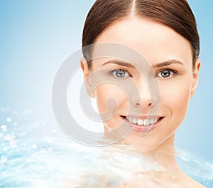 Face of beautiful young woman and water splash