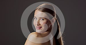 Face, beauty and happy woman wink for skincare, dermatology or flirt in studio isolated on black background mockup space