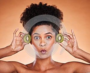 Face, beauty and kiwi with a model black woman in studio on a beige background to promote natural treatment. Portrait