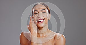 Face, beauty and skincare with smile of woman in studio on gray background for health, self love or wellness. Portrait