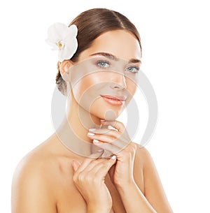 Face Beauty Woman. Smooth Skin Care Spa Cosmetics. Beautiful Model with Full Lips and Natural Makeup with Orchid Flower over White