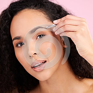 Face, beauty and woman with tweezer for eyebrow in studio isolated on pink background. Natural portrait, facial plucking
