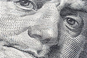 The face of Benjamin Franklin on a hundred-dollar bill