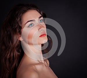 Face, blue contact lenses, black background, serious