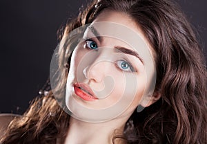 Face, blue contact lenses, black background, serious