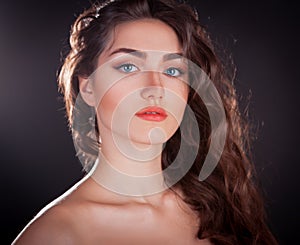 Face, blue contact lenses, black background, serious