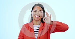 Face, business and woman with ok hand at studio isolated on a blue background. Portrait, okay sign and happy Asian