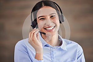 Face of businesswoman working in a call center. Customer service operator wearing a headset. Portrait of happy service