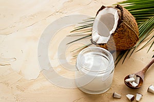Face care. Coconut cream in glass jar on beige background copy space