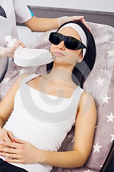 Face Care. Facial Laser Hair Removal. Beautician Giving Laser Epilation Treatment To Young Woman`s Face At Beauty Clinic. Body Ca