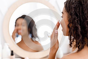 Face Care. Young Black Woman Applying Spf Protection Cream On Skin