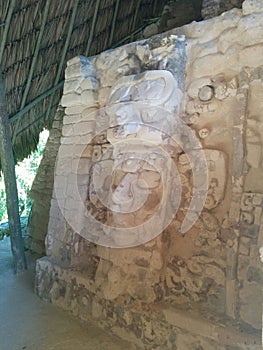 Face carved in stone in Mayan ruins