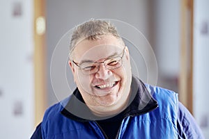 Face of Caucasian man in his 40s with mocking laugh and an insolent grin. photo