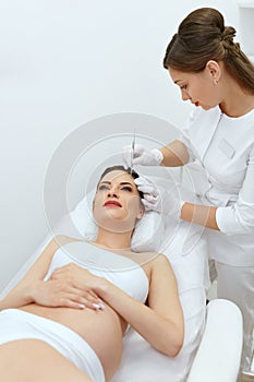 Face Cleaning Procedure. Pregnant Woman At Cosmetology Clinic