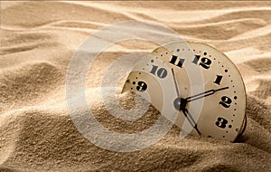 Face of clock in sand