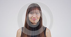 Face, comedy and funny with an asian woman in studio on a white background for freedom, humor or laughter. Portrait