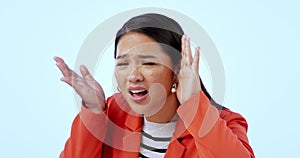 Face, confused and hearing with an asian woman in studio on a blue background listening to gossip. Portrait, frustrated