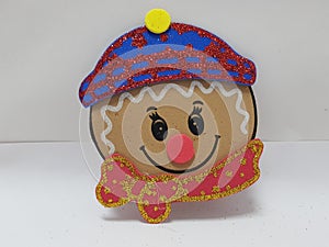 face of cookie with blue Hat and ted scarf