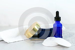 Face cream and bottle of anti-aging serum