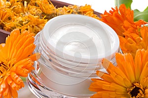 Face cream and calendula flowers