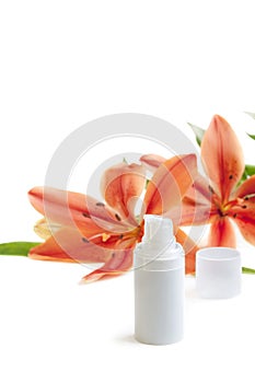 Face cream with lily flowers, on white