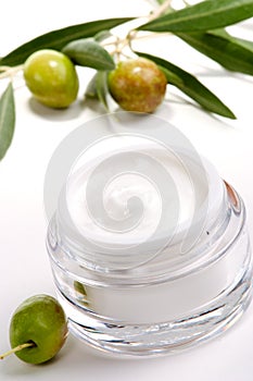 Face cream and olive twig