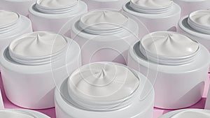 Face cream in white jars moves. Cosmetic products for makeup and skincare.