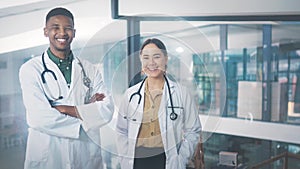 Face, doctors and man with woman, smile and employees in a hospital, medical and professional. Portrait, teamwork and