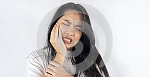 Face expression suffering from sensitive teeth and cold, asian young woman, girl feeling hurt, pain touching cheek, mouth with