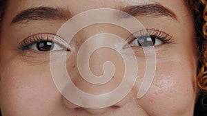 Face, eyes and woman closeup in studio for beauty, makeup and skincare treatment, happy and cheerful. Portrait, lash and