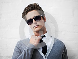 Face, fashion and sunglasses with cool man in studio on white background for attitude or style. Portrait, shades and tie